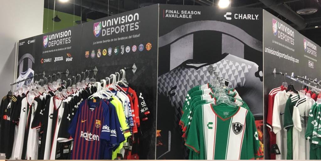 Univision Deportes and Charly branded jersey wall at a trade show
