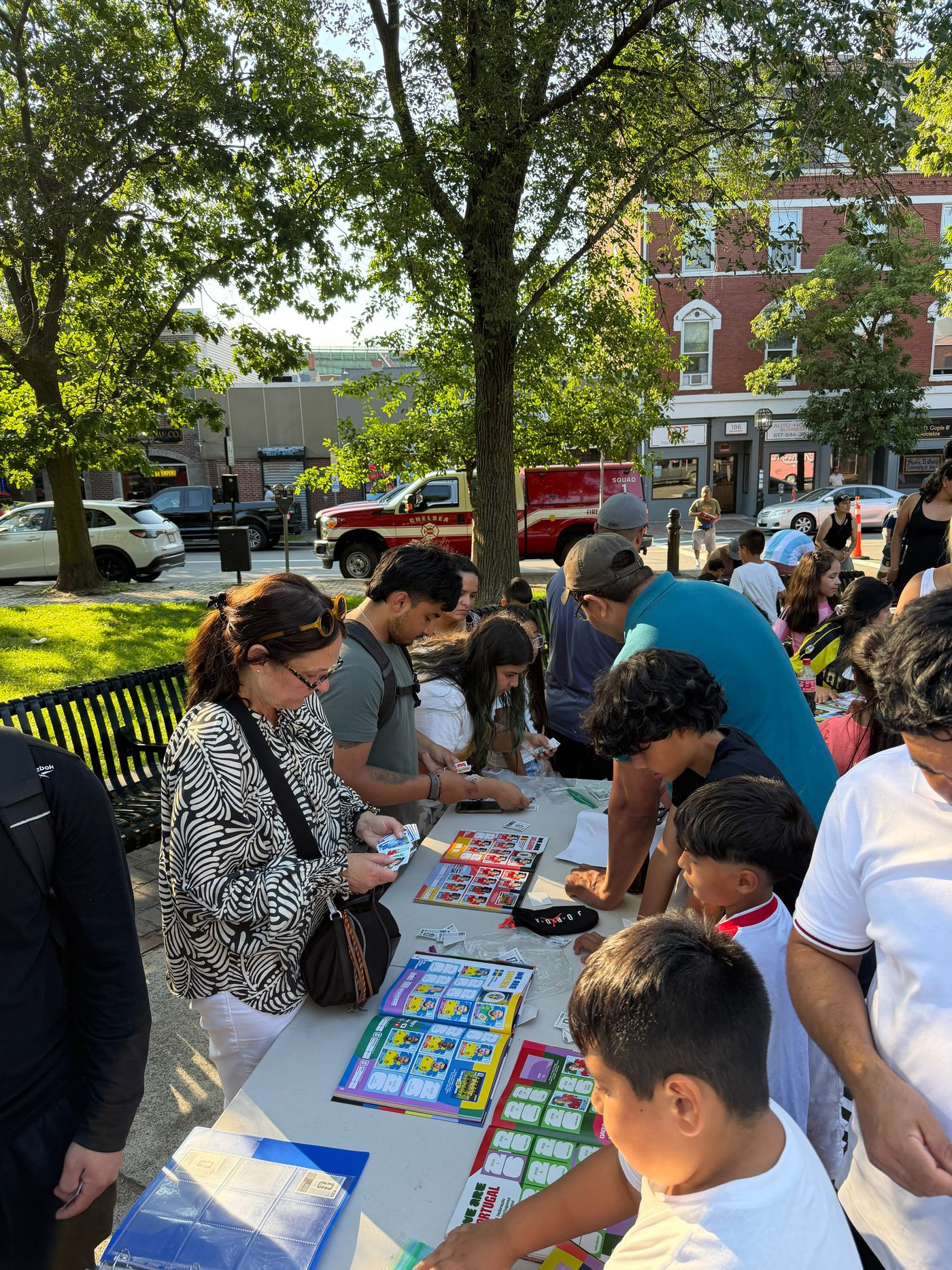 Families trading Panini stickers at a Campeon Soccer event in Chelsea, Massachusetts